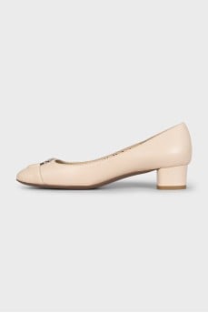 Beige leather shoes with a silver logo