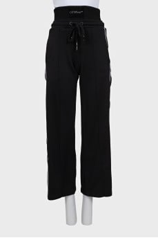 Black sports pants with a signature print