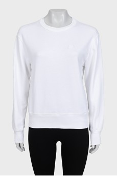 White sweatshirt with a branded patch
