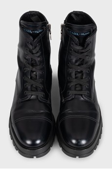Black leather boots with a zipper and laces