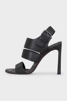 Black leather sandals with a decorated strap
