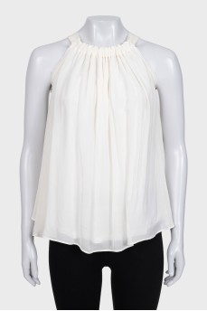 White pleated sleeveless blouse