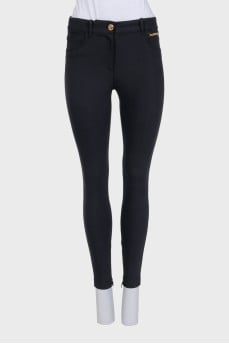 Tapered black trousers with gold hardware