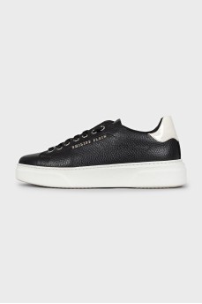 Black leather sneakers with silver logo