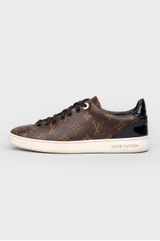 Sneakers in the print of the log of brand
