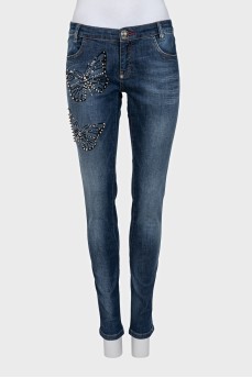 Blue jeans with a print decorated with rhinestones