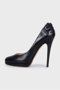 Black leather shoes with embellishments on the back