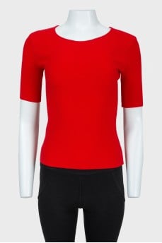 Red top with lacing on the back with a tag