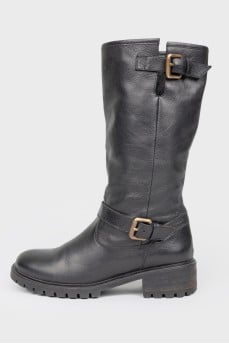Black leather boots on fur