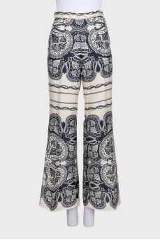 Beige straight-leg trousers with a print