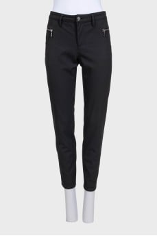 Black tapered trousers with a mid-rise