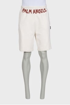 Men's beige shorts with a signature print