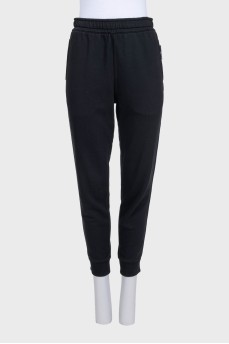 Black sports pants with a signature print
