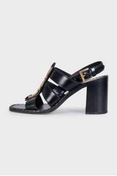 Black leather sandals with gold decor