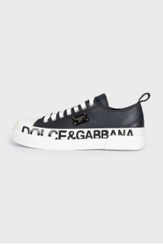 Black leather sneakers with a signature logo