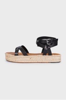 Black leather sandals with a woven sole