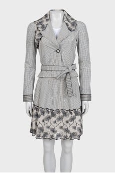 A checkered suit decorated with embroidered frills