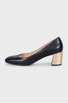 Black leather shoes with gold heels
