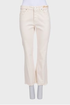 Straight-leg beige jeans with tag