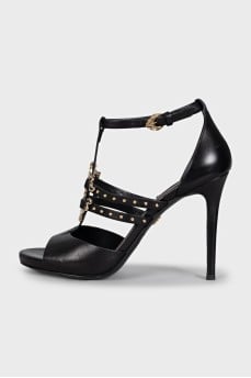 Black leather sandals with gold decor