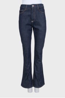 Blue flared jeans with a signature button