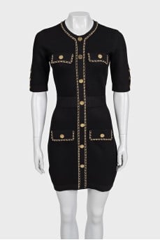 Black dress with gold trim and tag