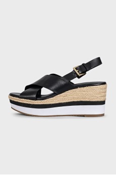 Black leather sandals with striped wedge heels