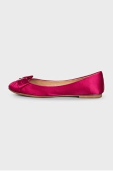 Pink ballet flats decorated with a bow