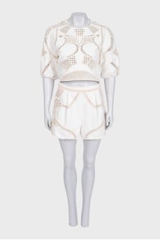 Beige suit with shorts decorated with perforations