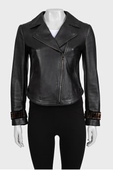 Black leather jacket with textile inserts on the sleeves