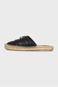 Black mules with a metallic logo