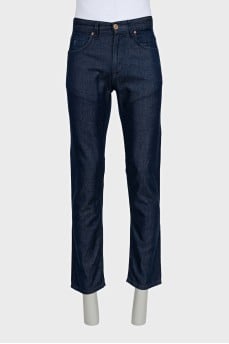 Men's dark blue jeans with embroidery on the pockets