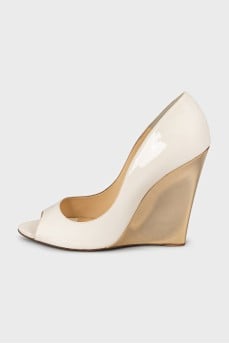 Beige sandals with a gold wedge heel