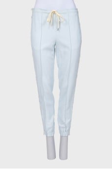 Tapered trousers decorated with lace