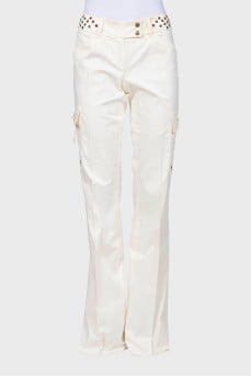 Flared trousers decorated with eyelets