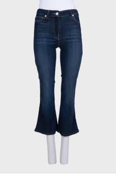 Blue flared jeans with a button