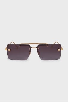 Sunglasses with a gold frame and a rectangular lens