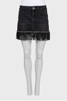 Black denim mini skirt decorated with fringe