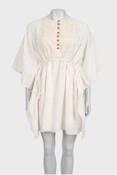 White dress with branded print and tag