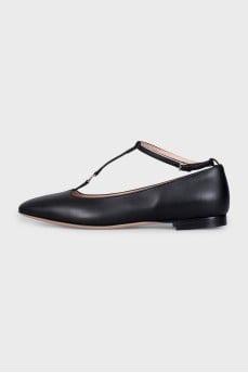 Black leather ballet flats with a tag strap
