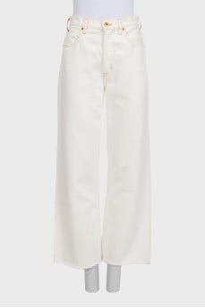 White wide-leg jeans with raw hems