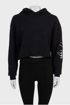 Black cropped hoodie with contrasting print on the sleeve