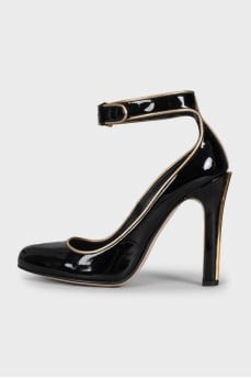 Black leather shoes with gold trim