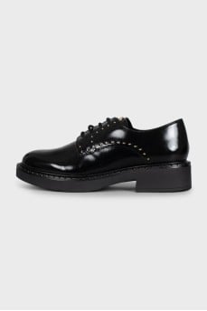 Black leather derby shoes with gold trim