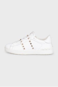 White leather sneakers decorated with studs