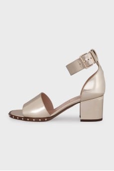 Gold-color leather sandals decorated with studs
