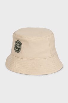 Beige panama hat decorated with a patch