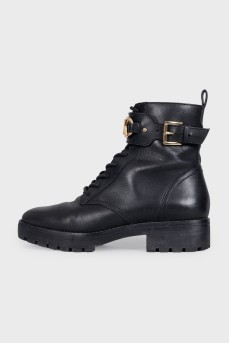 Black leather boots with gold-tone hardware