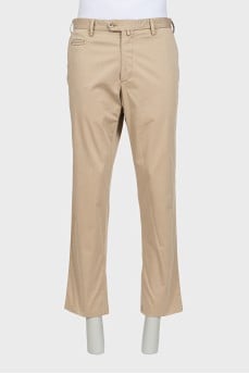 Men's beige trousers with a zipper and buttons