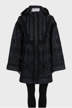 The black jacket is decorated with lace